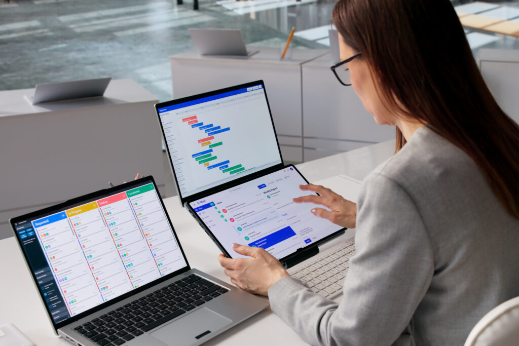 Agile Business Trainer Organizes Schedule While Reviewing Emails On Laptop
